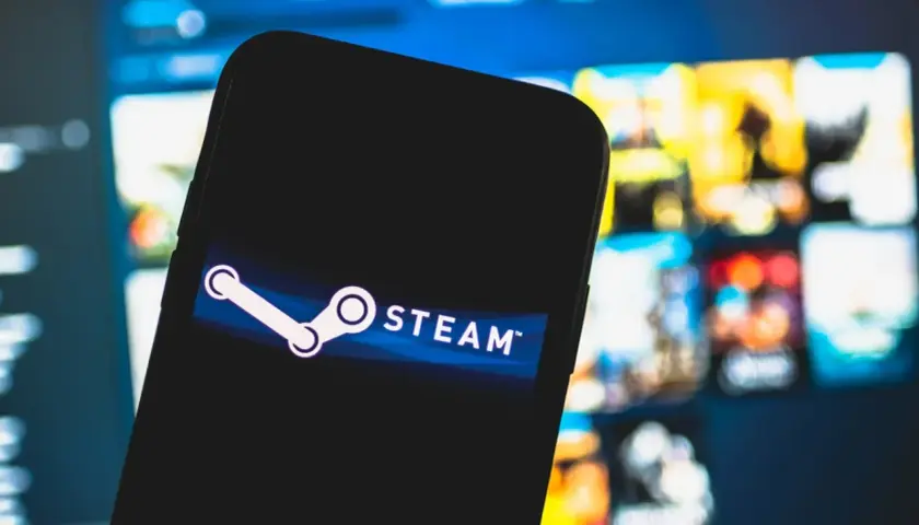 Telefon z logo Steam na tle ekranu z grami.